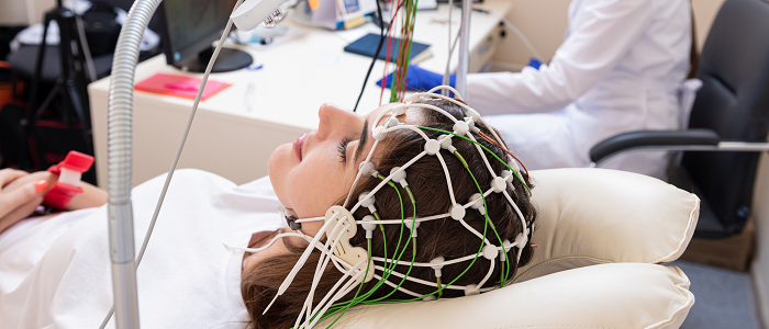 Female patient wearing encephalography equipment on her head