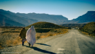 A photo of two women walking along a road in Balochistan, Pakistan
