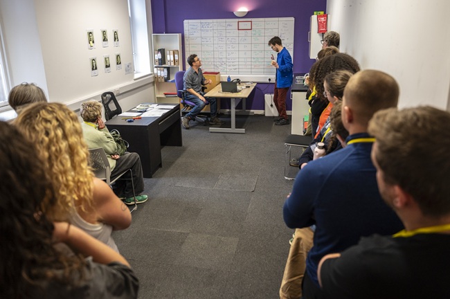 Participants watch a scene where the production team feel the pressure of a demanding shooting schedule in a scene from the Set Ready Safety immersive training programme. Actors: Dave Gerow and Jack Hunter. Credit: Tim Anger