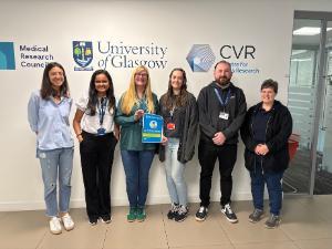 CVR sustainability team - 5 women and a man - holding the LEAF silver certificate in front of decals of the centre logo on a white wall