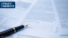 A photo of a pen on top of a contract, text reads Policy Insights