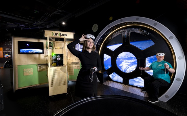 Dr Lynn Verschuren of the University of Glasgow’s Museums in the Metaverse team and Derek Shirlaw of the Glasgow Science Centre try out the un[box] VR kiosk at the Glasgow Science Centre. Credit Martin Shields