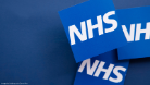 A blue graphic with the NHS logo on laid out cards